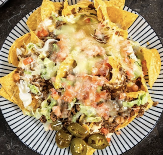 Tirado's Taqueria signature dishes Loaded NachosBirria PizzaTamales